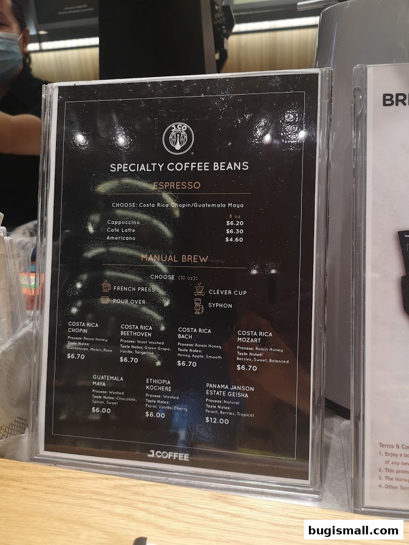A menu board displaying specialty coffee beans and espresso drinks with prices.