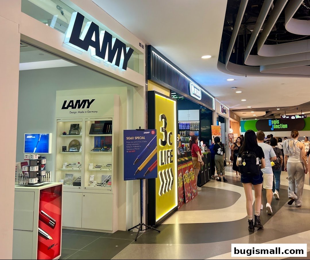 The LAMY store front displays pens and writing instruments in a well-lit mall setting.