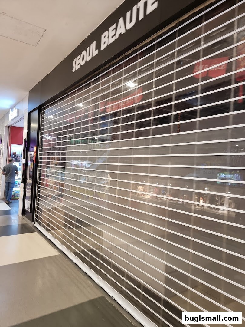 The exterior of the Seoul Beaute shop with its roller shutter down.