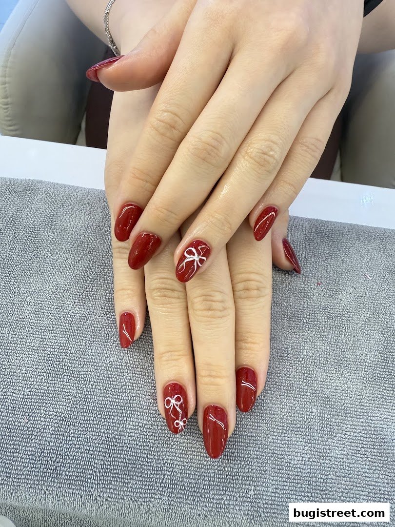 Stunning Red Nails with Chic Bow Accents