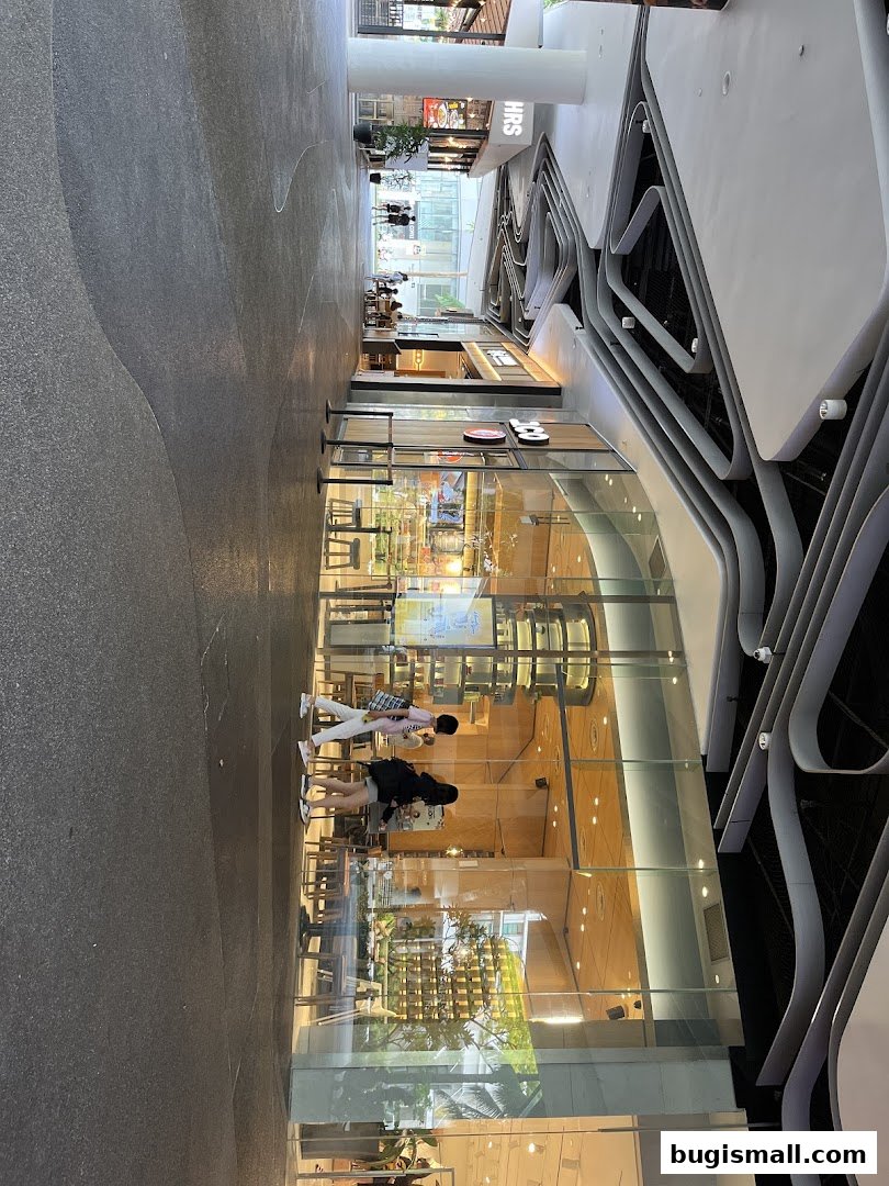 A modern shop front with large glass windows and interior seating, showcasing a vibrant atmosphere.